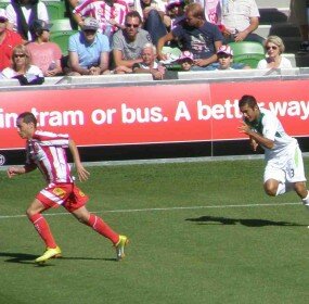 Melbourne Heart's Adrian Zahra streaks clear of Bradley McDonald of North Queensland Fury